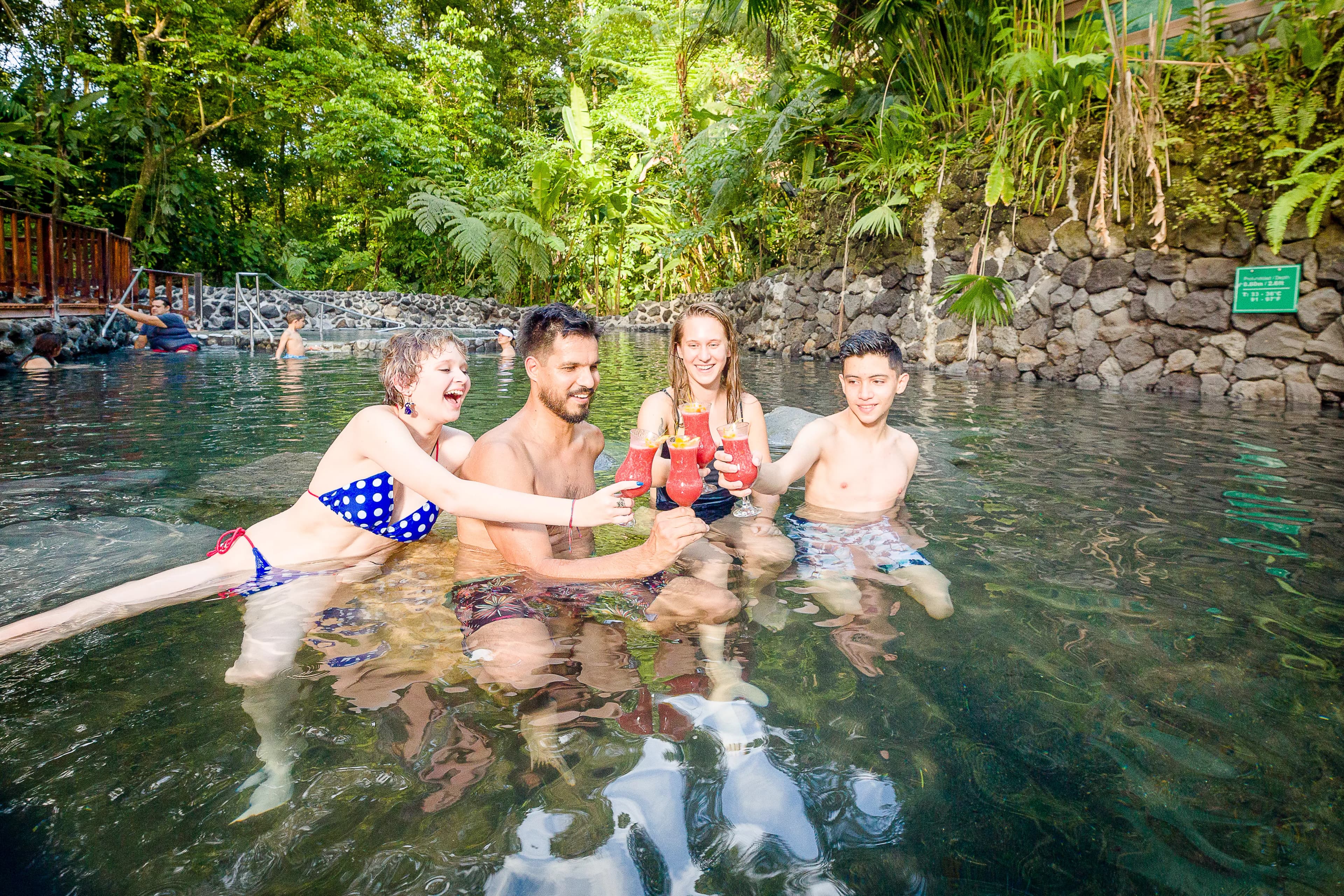 Family enjoy a drinks cheers at Ecotermales Hot Springs
